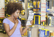 African American woman reading instructions on a product at super market