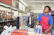 Photo: African American male store clerk at checkout counter in super market African American male store clerk at checkout counter in super market