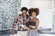 Photo: Portrait of young African American couple with color swatches in new kitchen Portrait of young African American couple with color swatches in new kitchen