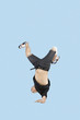 Break dancer on one arm over blue background