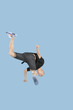Teenage boy break dancing over blue background