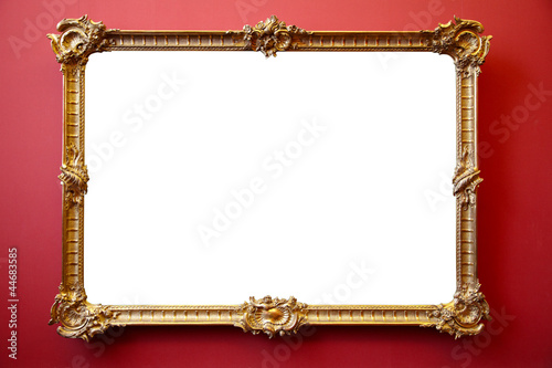Photo: Picture gold frame on red painted wall Picture gold frame on red painted wall