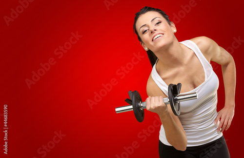Photo: Young woman holding dumbells Young woman holding dumbells