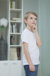 Little boy lost in thoughts at home