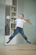 Portrait of a boy in casuals jumping in mid-air