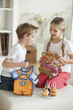 Siblings looking into each others bags