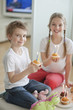 Portrait of siblings celebrating birthday with cup cakes