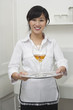 Portrait of female housekeeper serving wine in goblet