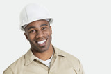 Photo: Portrait of happy African construction over with hardhat over gray background Portrait of happy African construction over with hardhat over gray background