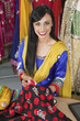 Photo: Portrait of an Indian female dressmaker matching thread color with the cloth Portrait of an Indian female dressmaker matching thread color with the cloth