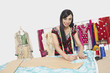 Photo : Portrait of beautiful Indian female fashion designer working Portrait of beautiful Indian female fashion designer working