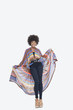 Photo: Full length portrait of an attractive African American in traditional wear standing over gray background Full length portrait of an attractive African American in traditional wear standing over gray background