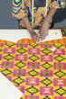 Photo: Midsection of female fashion designer marking pattern with chalk on fabric textile Midsection of female fashion designer marking pattern with chalk on fabric textile