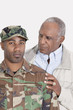 Photo: Portrait of an African American US Marine Corps soldier with father over gray background Portrait of an African American US Marine Corps soldier with father over gray background