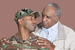 Foto: Father and US Marine Corps soldier looking at each other over brown background Father and US Marine Corps soldier looking at each other over brown background