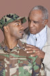 Foto: Father and US Marine Corps soldier looking at each other over brown background Father and US Marine Corps soldier looking at each other over brown background