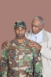 Foto: Portrait of African American male US Marine Corps soldier with father over brown background Portrait of African American male US Marine Corps soldier with father over brown background