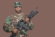Foto: Portrait of African American US Marine Corps soldier holding M4 assault rifle over brown background Portrait of African American US Marine Corps soldier holding M4 assault rifle over brown background