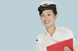 Foto: Happy female US Navy officer with clipboard smiling over light blue background Happy female US Navy officer with clipboard smiling over light blue background