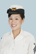 Foto: Portrait of a young beautiful US Navy officer smiling over light blue background Portrait of a young beautiful US Navy officer smiling over light blue background