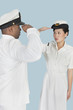 Foto: Multi-ethnic US Navy officers saluting each other over light blue background Multi-ethnic US Navy officers saluting each other over light blue background