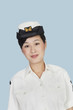 Portrait of a beautiful young US Navy officer over light blue background