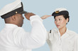 Foto: Multi-ethnic US Navy officers saluting each other over light blue background Multi-ethnic US Navy officers saluting each other over light blue background