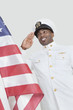Foto: Portrait of a happy young US Navy officer saluting American flag over gray background Portrait of a happy young US Navy officer saluting American flag over gray background