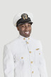 Foto: Portrait of a young African American US Navy officer smiling over gray background Portrait of a young African American US Navy officer smiling over gray background