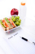Healthy packed lunch with empty food diary copy space