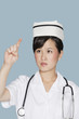 Young nurse using transparent screen over light blue background