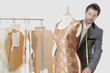 Mature male tailor working on an outfit in design studio