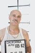 Foto: Mug shot of senior gangster smoking cigarette Mug shot of senior gangster smoking cigarette