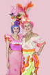 Photo: Portrait of happy young and senior women in Brazilian outfits over pink background Portrait of happy young and senior women in Brazilian outfits over pink background