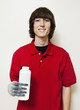Photo: Portrait of a happy young man holding bottle with prosthetic hand over gray background Portrait of a happy young man holding bottle with prosthetic hand over gray background