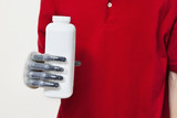 Photo: Mid section of a man holding bottle with prosthetic hand over gray background Mid section of a man holding bottle with prosthetic hand over gray background