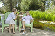 Photo: Mature woman and mother relaxing with man and child fishing in the background Mature woman and mother relaxing with man and child fishing in the background