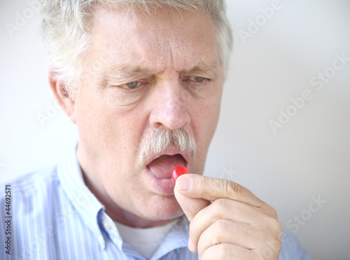 Photo: senior man with cough drop senior man with cough drop