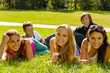 Photo: Students laying on grass in park campus Students laying on grass in park campus