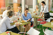 Businesswomen talking business in lunch break cafe