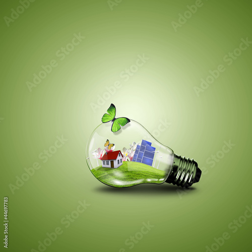 Photo: Electric light bulb and house inside it Electric light bulb and house inside it