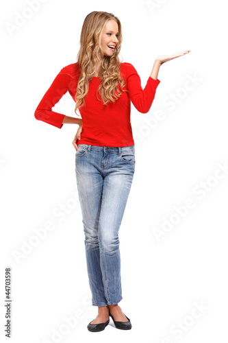 Photo: happy young blonde woman holding something over her palm happy young blonde woman holding something over her palm