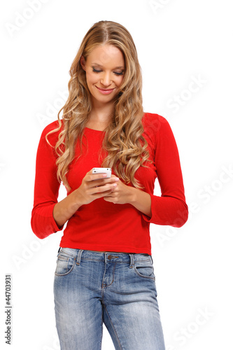Photo: cute young blond woman reading an SMS on mobile cute young blond woman reading an SMS on mobile