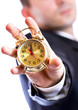 Business man holding a golden clock