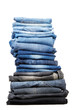 Many jeans stacked in a pile isolated on white