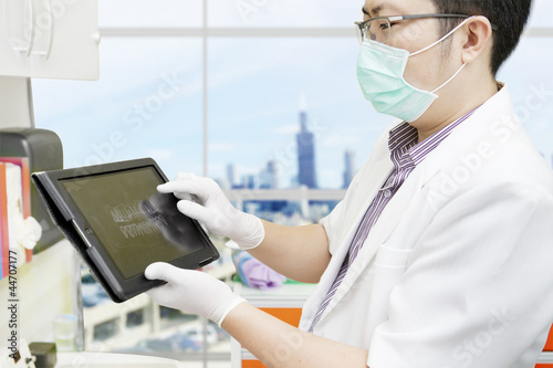 Photo: Dentist with computer tablet Dentist with computer tablet