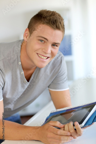 Photo: Portrait of student using electronic tablet Portrait of student using electronic tablet