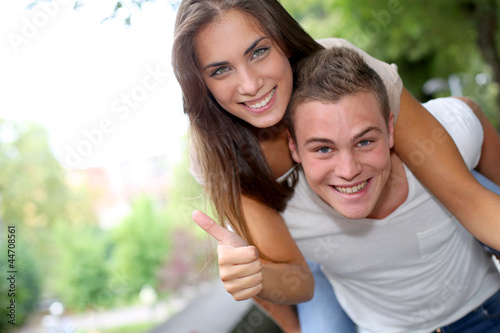 Photo: Young man carrying girlfriend on his back Young man carrying girlfriend on his back