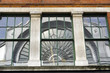 Arched window reflected in building glass