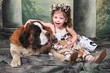 Adorable Child and Her Saint Bernard Puppy Dog